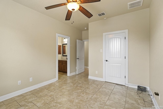 100 Vintage Ranch Cir, La Vernia, TX 78121 - unfurnished bedroom featuring baseboards, connected bathroom, and a ceiling fan