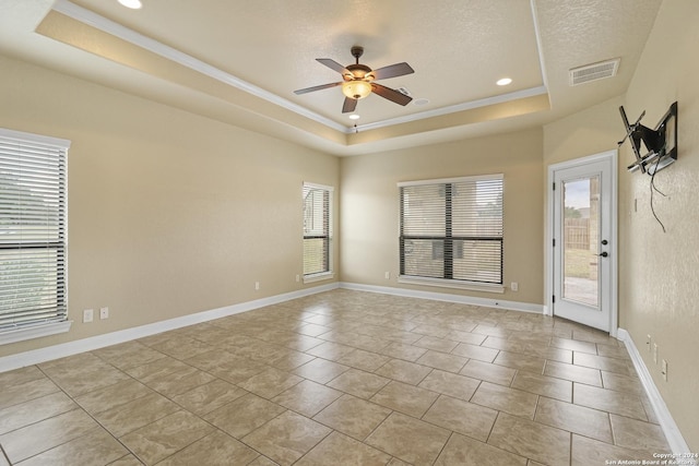 100 Vintage Ranch Cir, La Vernia, TX 78121 - spare room with a tray ceiling, a ceiling fan, crown molding, recessed lighting, and light tile patterned floors