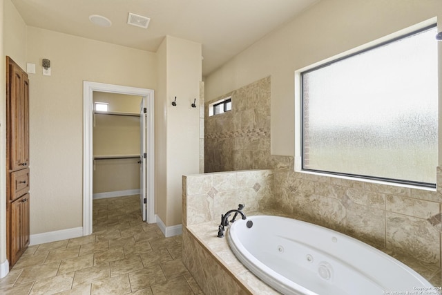 100 Vintage Ranch Cir, La Vernia, TX 78121 - full bathroom featuring a jetted tub, a walk in closet, and baseboards