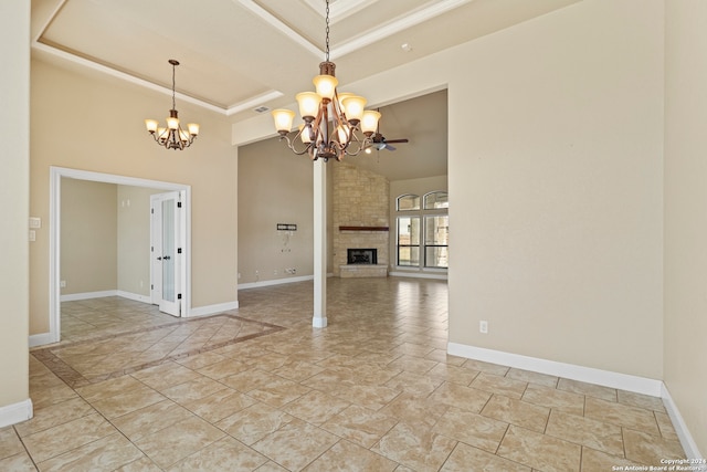 unfurnished living room featuring a tray ceiling, a fireplace, and ceiling fan with notable chandelier