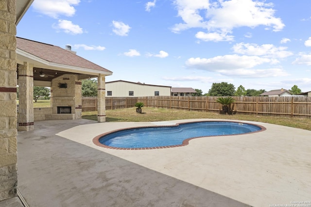 100 Vintage Ranch Cir, La Vernia, TX 78121 - view of pool with an outdoor stone fireplace, a patio, and a fenced backyard
