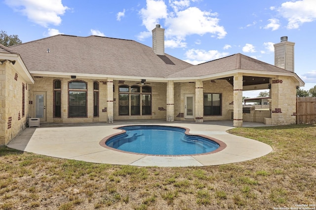 view of pool with a patio area, ceiling fan, and a yard