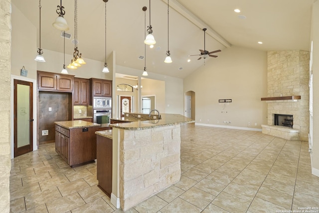 100 Vintage Ranch Cir, La Vernia, TX 78121 - kitchen featuring stainless steel appliances, a large island, high vaulted ceiling, ceiling fan, and arched walkways