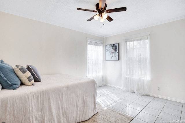 tiled bedroom with a textured ceiling, ceiling fan, and crown molding