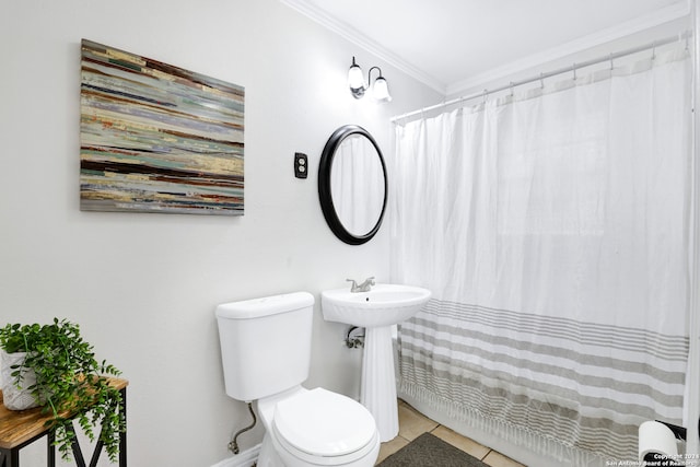 bathroom with tile patterned floors, toilet, sink, and ornamental molding