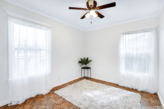 spare room with ceiling fan and crown molding