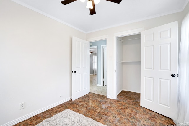 unfurnished bedroom with ornamental molding, ceiling fan, and a closet