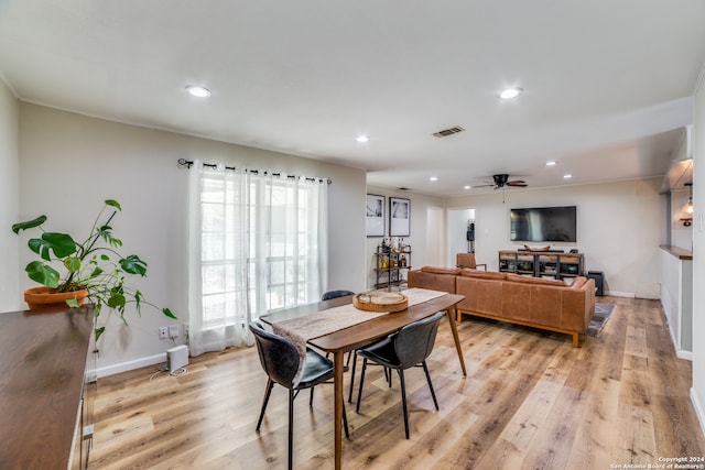 dining space with ceiling fan and light hardwood / wood-style flooring