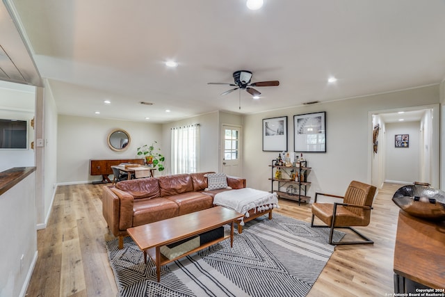 living room featuring light wood-type flooring and ceiling fan