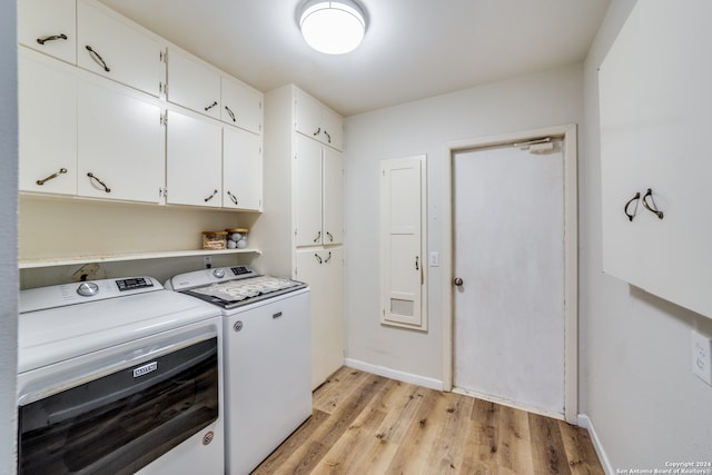 clothes washing area featuring light wood-type flooring, cabinets, and independent washer and dryer