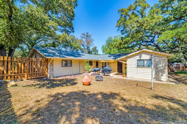 rear view of property with a yard and a patio area