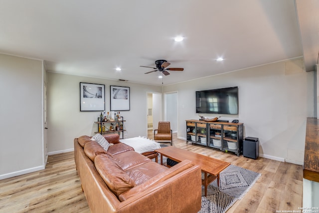 living room featuring light wood-type flooring and ceiling fan