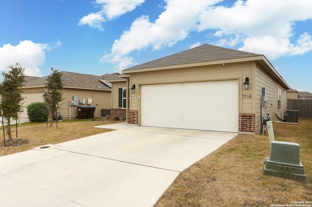 single story home with a garage and central AC