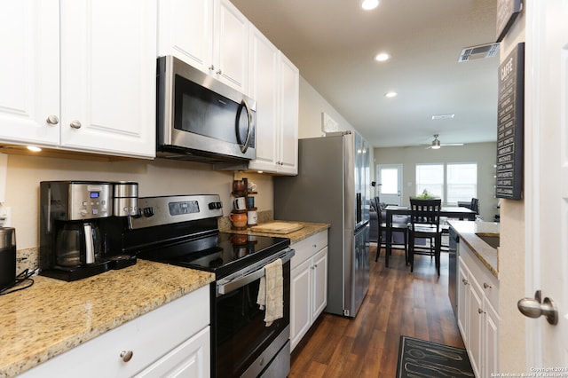 kitchen with light stone counters, stainless steel appliances, white cabinetry, dark hardwood / wood-style flooring, and ceiling fan