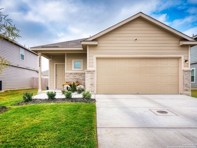 view of front of home with a garage and a front yard