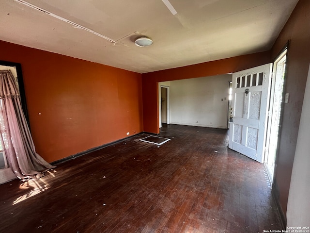 empty room with dark hardwood / wood-style flooring