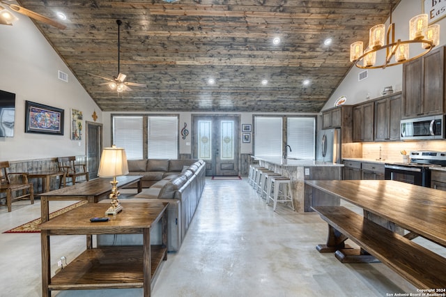 living room featuring sink, high vaulted ceiling, and ceiling fan