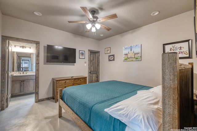 bedroom with ensuite bathroom, sink, and ceiling fan