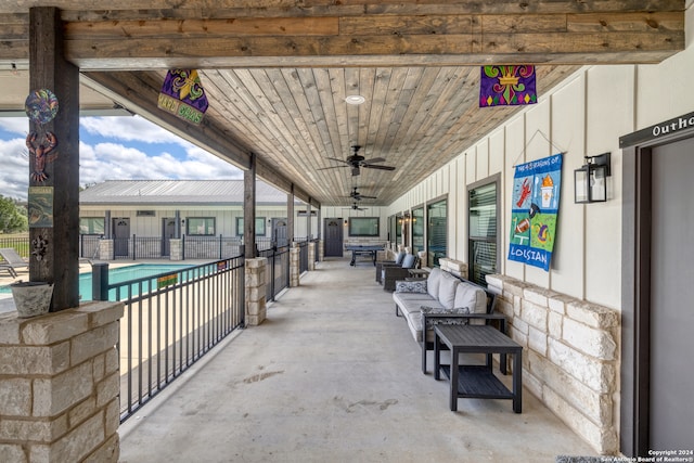 view of patio featuring an outdoor hangout area, a community pool, and ceiling fan