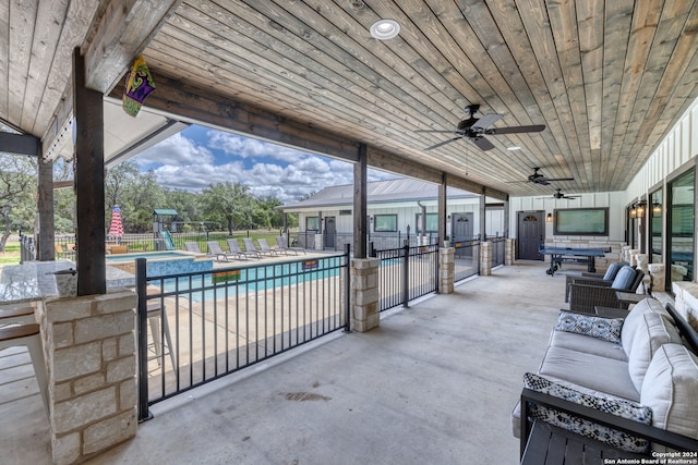 view of patio with a fenced in pool, outdoor lounge area, and ceiling fan