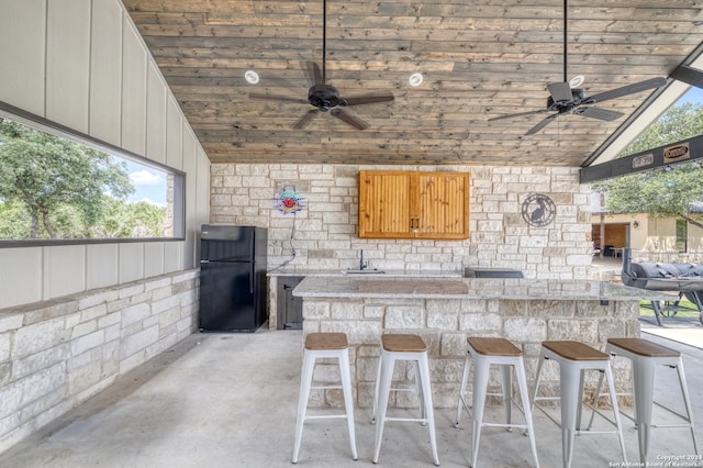 view of patio with a wet bar and ceiling fan