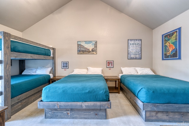 bedroom featuring lofted ceiling and light carpet