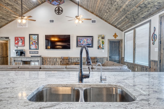 kitchen featuring light stone countertops, sink, high vaulted ceiling, and wood ceiling