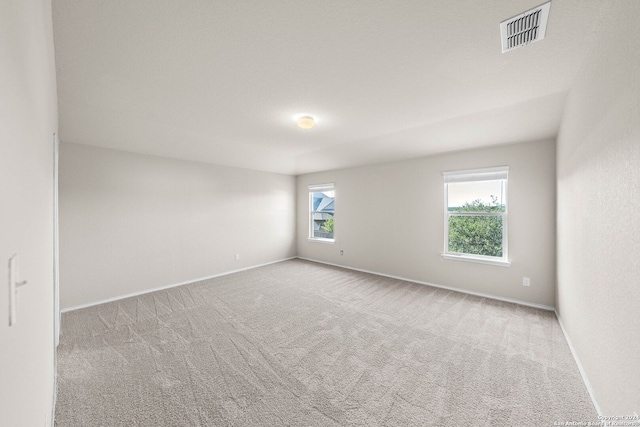 spare room with light carpet