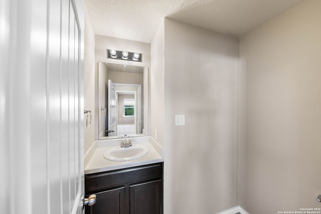 bathroom with vanity and a textured ceiling