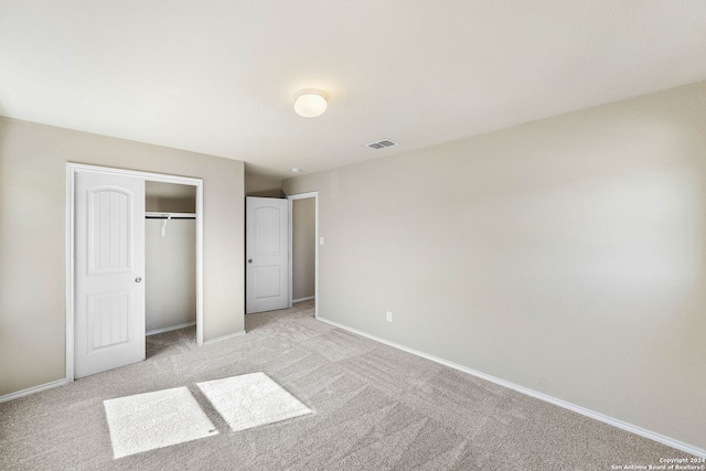 unfurnished bedroom featuring light carpet