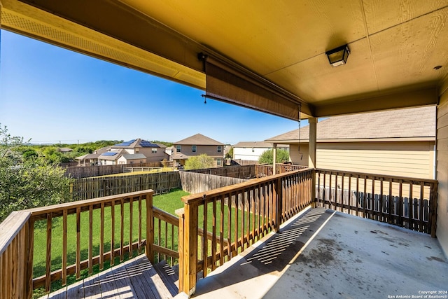 wooden terrace featuring a lawn