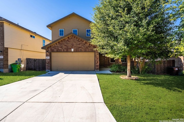 view of front of property featuring a garage and a front yard