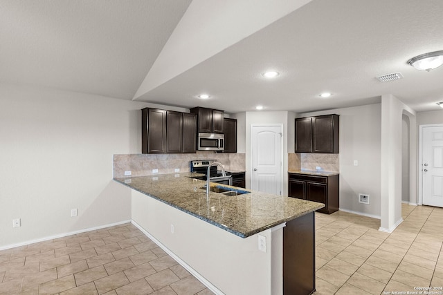 kitchen featuring dark brown cabinets, kitchen peninsula, appliances with stainless steel finishes, and sink