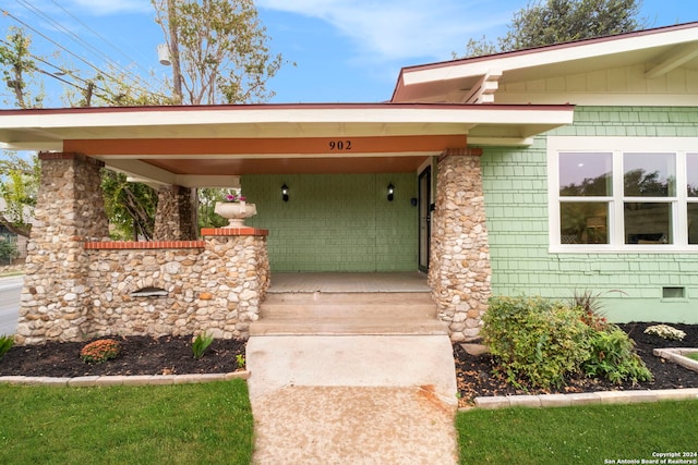 doorway to property with a carport