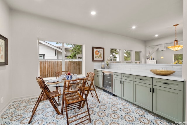 dining room featuring beverage cooler and plenty of natural light