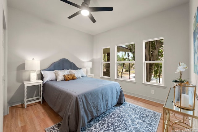 bedroom with light hardwood / wood-style flooring and ceiling fan