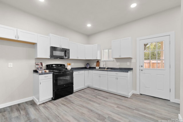 kitchen with white cabinetry, sink, black appliances, and light hardwood / wood-style flooring