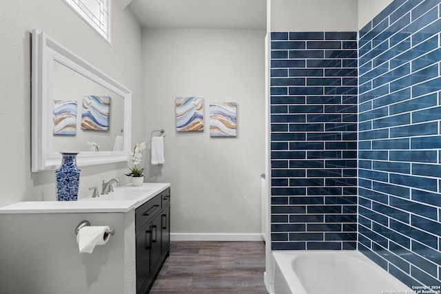 bathroom featuring hardwood / wood-style flooring, vanity, and a bathtub