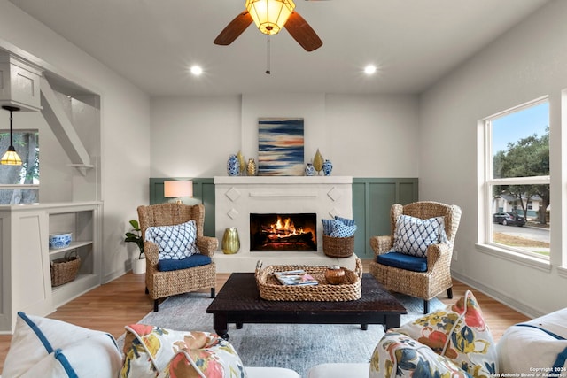 living room featuring light hardwood / wood-style floors and ceiling fan