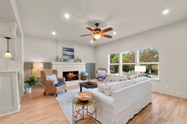 living room featuring light hardwood / wood-style floors and ceiling fan