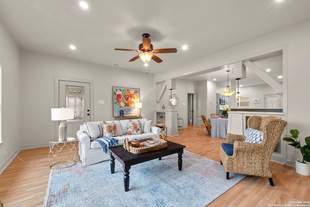 living room with ceiling fan and light hardwood / wood-style floors