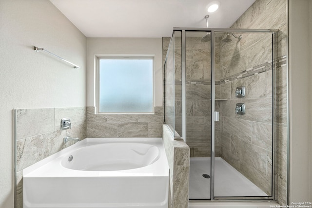 bathroom featuring separate shower and tub