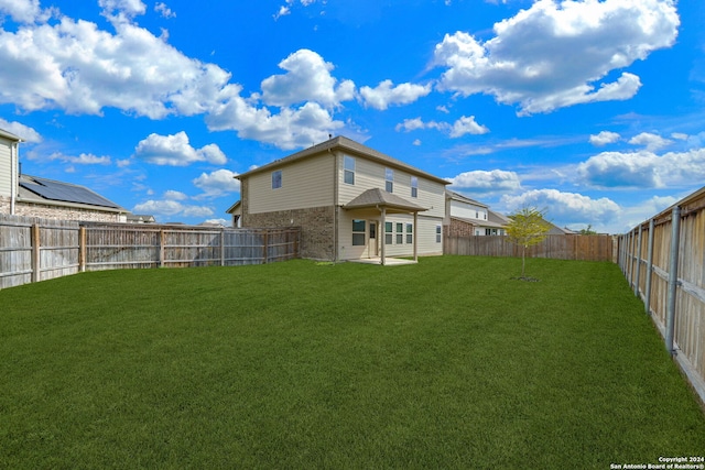 rear view of house with a yard