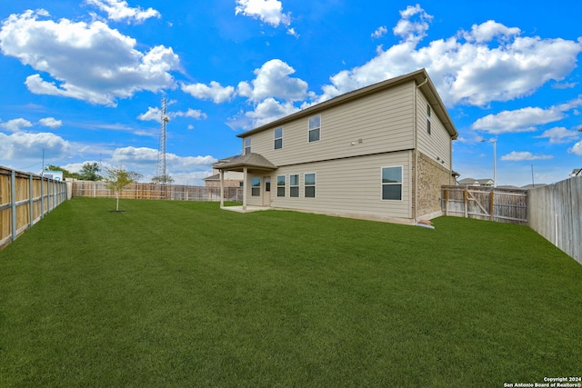 back of property featuring a patio and a lawn