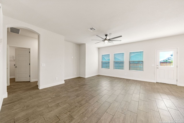 empty room with ceiling fan and dark hardwood / wood-style flooring