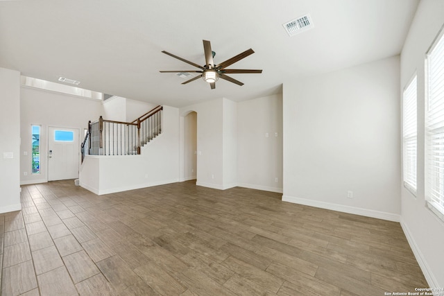 unfurnished living room with light hardwood / wood-style flooring and ceiling fan