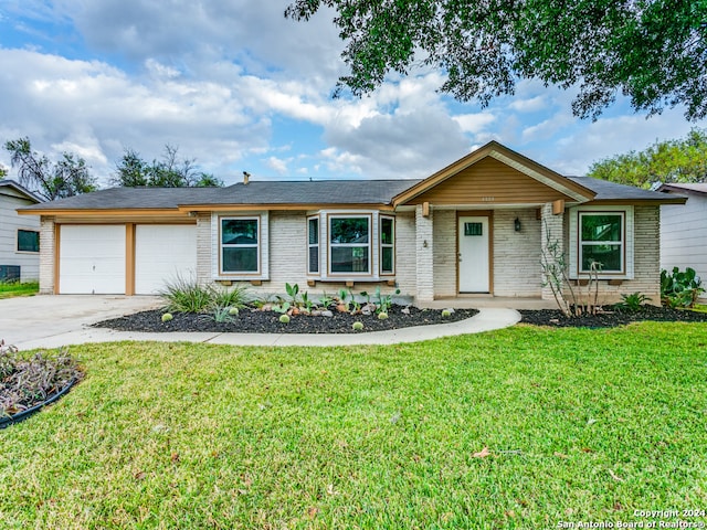 ranch-style home featuring a garage and a front yard