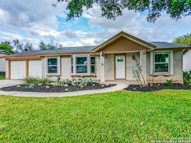 single story home with a garage and a front yard