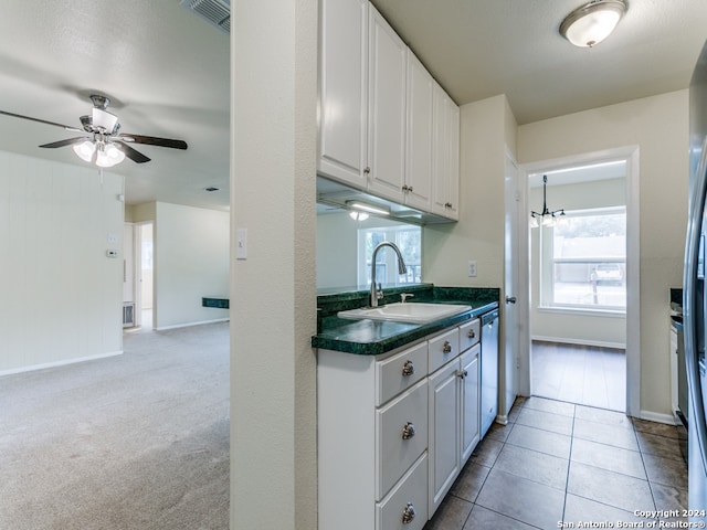 kitchen with white cabinetry, sink, light carpet, and stainless steel dishwasher