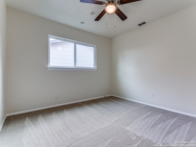 empty room with carpet floors and ceiling fan